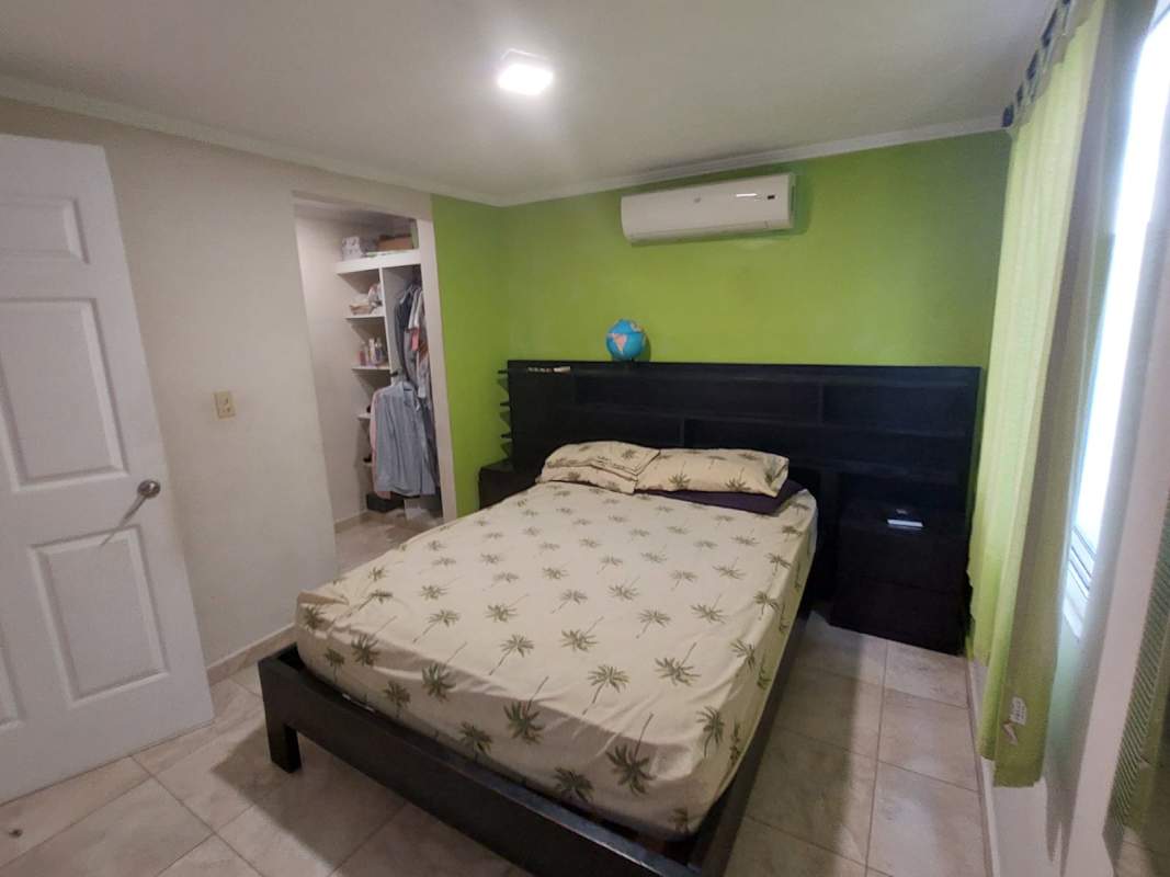 Bright child bedroom with red curtains ceiling fan AC and wardrobe PH Girasoles Panama