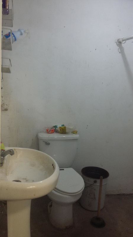 Simple office with AC lighting and workstations inside industrial building Panama