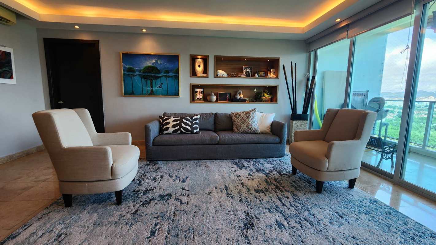 Open dining area adjoining living room with large windows and views in PH Titanium Costa del Este Panama