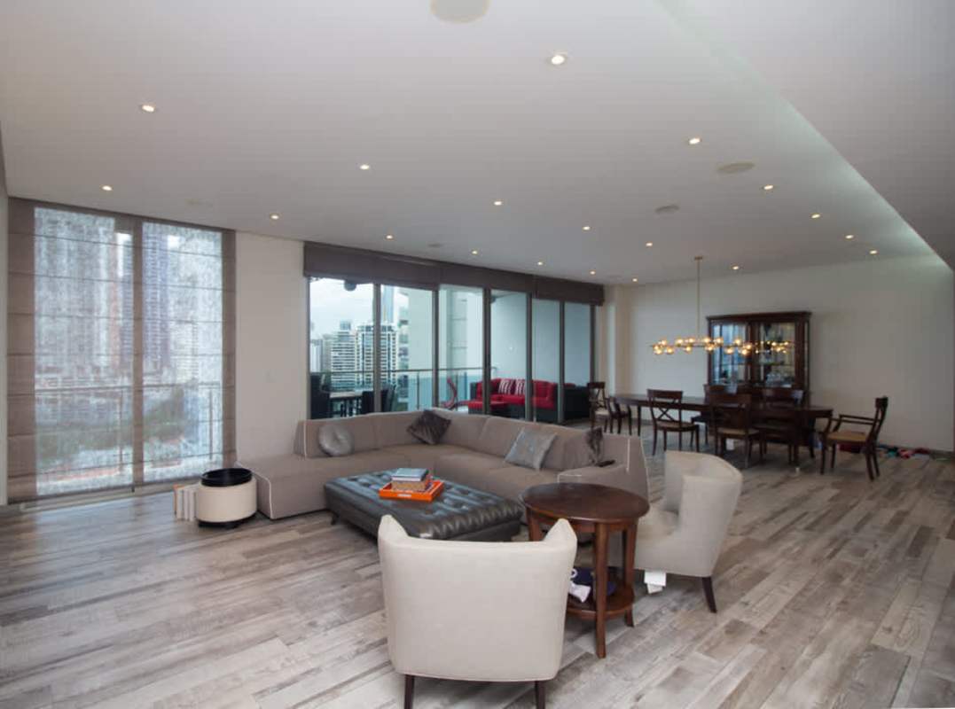 Contemporary living space with large windows and city skyline views in luxury condo Punta Pacifica Panama