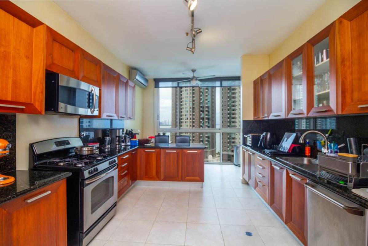 Ocean view balcony with dining and lounge areas in luxury condo tower PH Aqualina Punta Pacifica