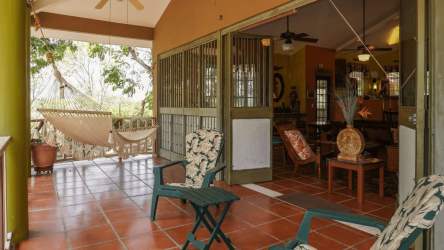 Cozy covered terrace with view of lush tropical garden in Coronado Panama beach house