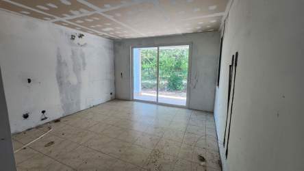 Modern single story house facade with carport, gated front porch in Residencial Malibu Nueva Gorgona