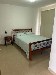 Modern kitchen with granite counters, black cabinets, appliances in Ibiza Residences Rio Hato Panama