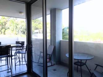 Contemporary kitchen in PH Mosaic Panama Pacifico with stainless steel appliances and wood cabinetry