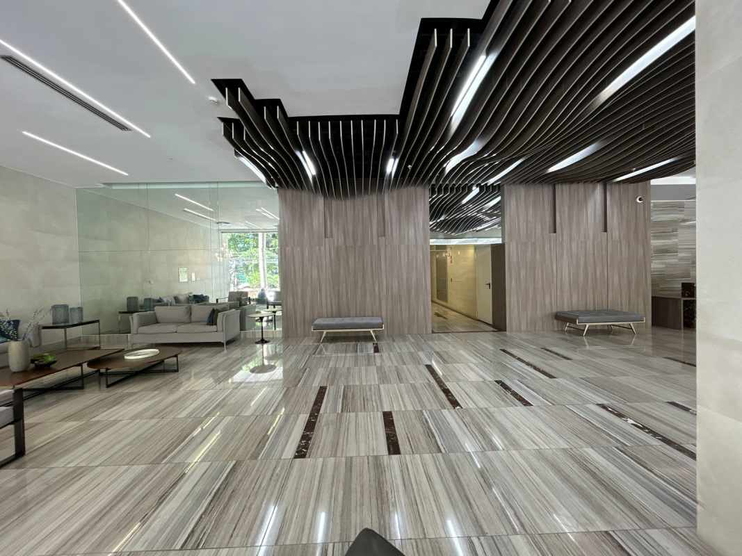 Luxurious lobby at PH BICSA Financial Center with marble finishes and concierge desk