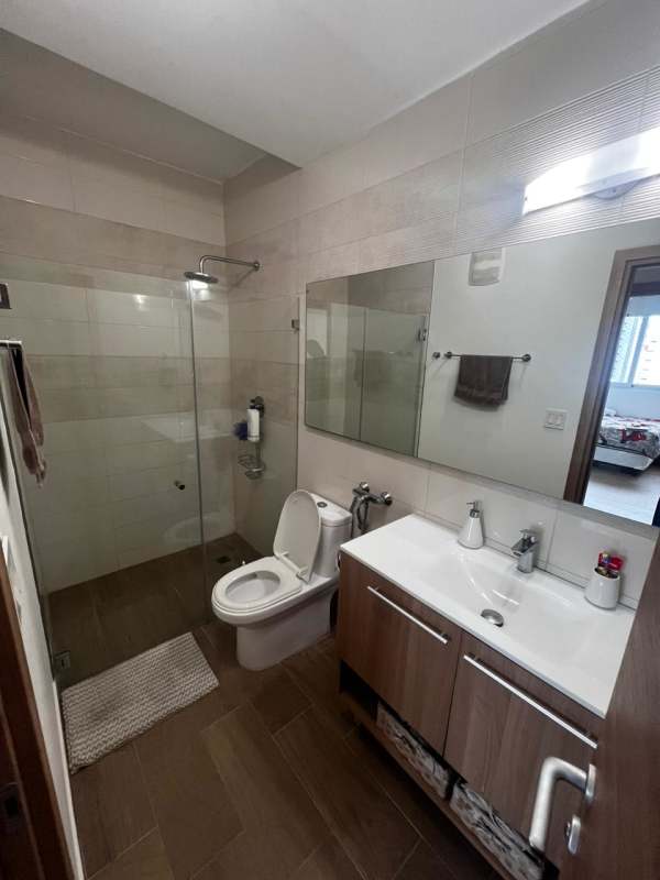 Spacious bedroom with large windows and skyline view in BICSA Tower Panama City