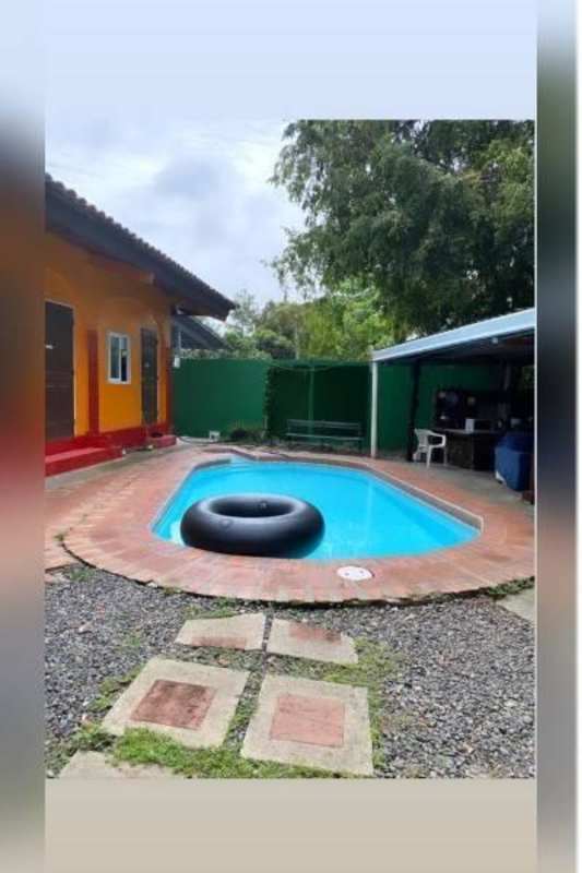 Rustic covered terrace with built-in TV, BBQ kitchen and lounge chairs rental complex