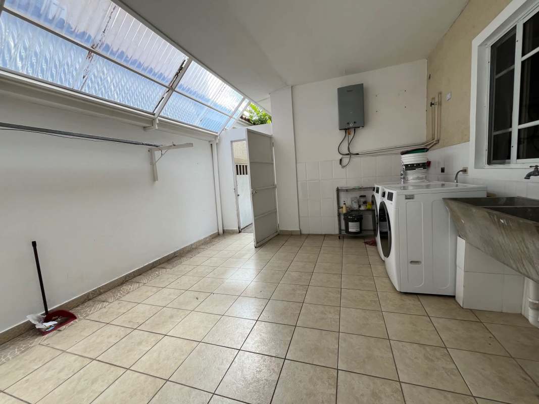 Laundry room with washer dryer, utility sink and sloped roof Costa del Este Panama