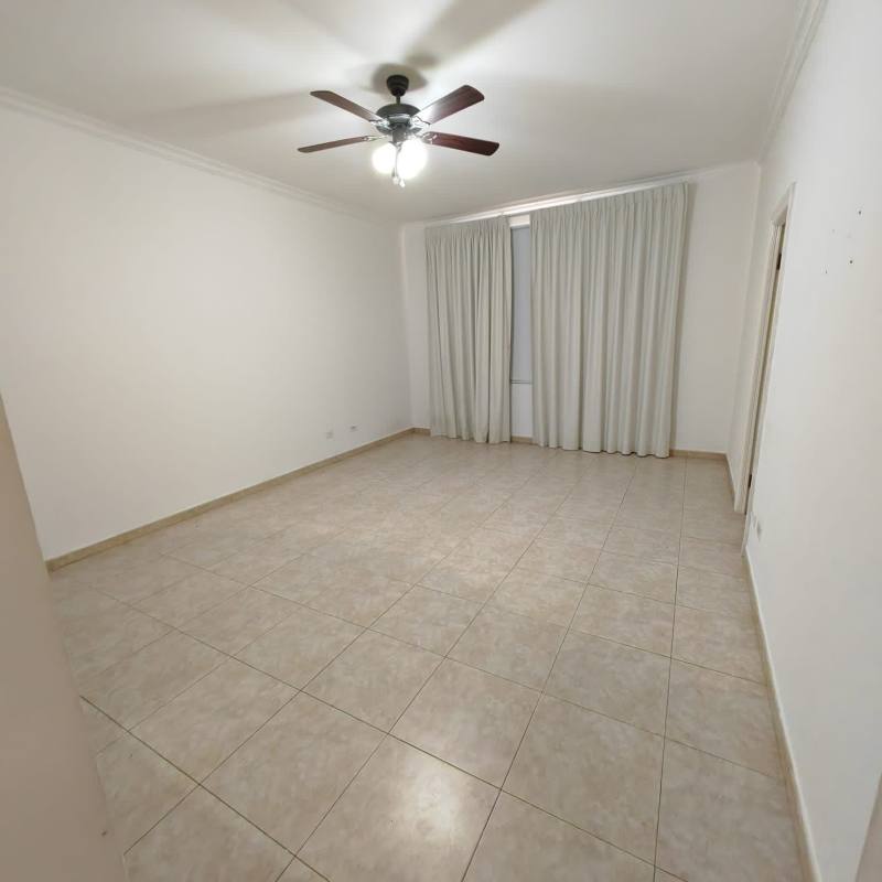 Empty living area with tiled floor and ceiling fan in duplex house Costa del Este Panama