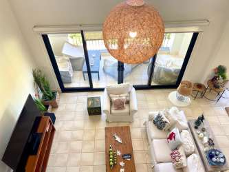 Living area opening to private balcony overlooking gardens Buenaventura duplex condo for sale