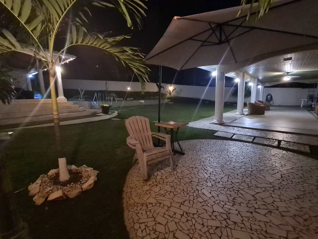 Mediterranean-style yellow two-story house with balcony, carport and tiled roof in Villa Zaita Panama