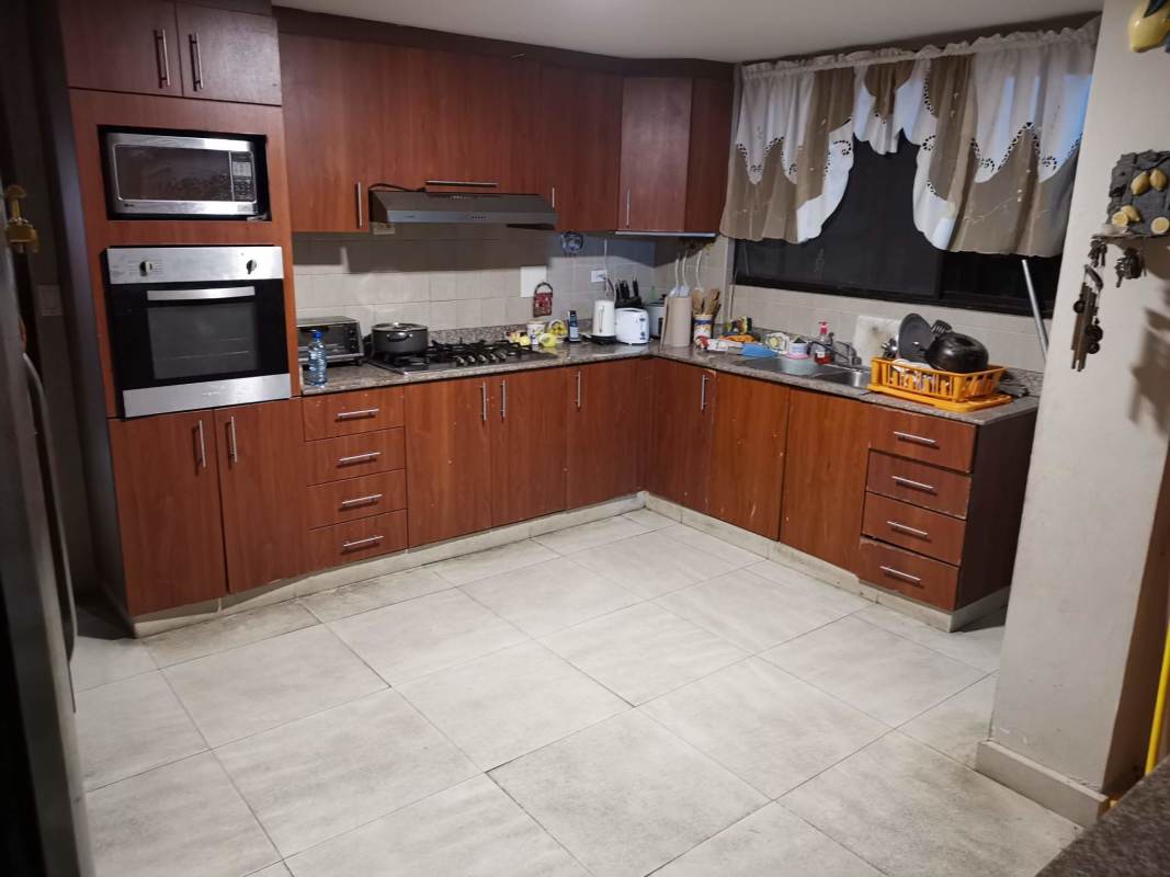 Large L-shaped kitchen with granite counters, built-in microwave, oven and window Villa Zaita house