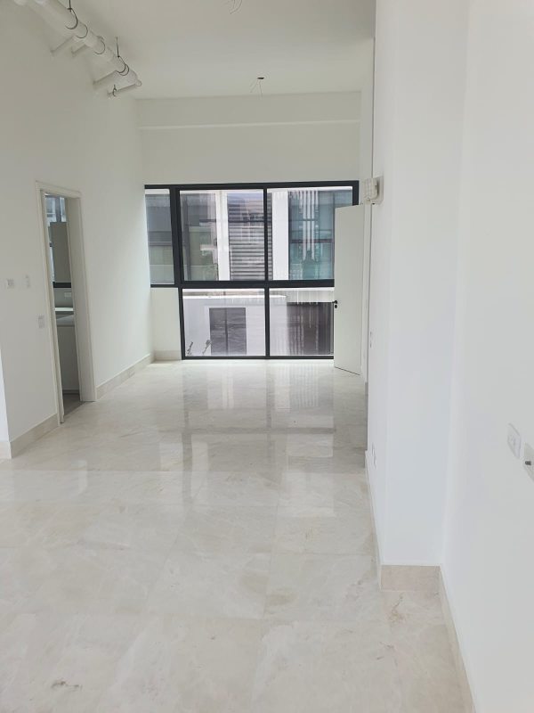 Bright spacious living room with large windows and city skyline view in Ocean Reef Islands City Villa Panama