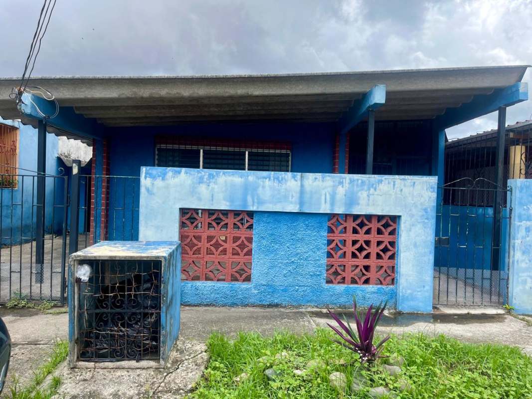 Blue front of one-story house with iron gate and fence in Villa Venus Juan Díaz Panama