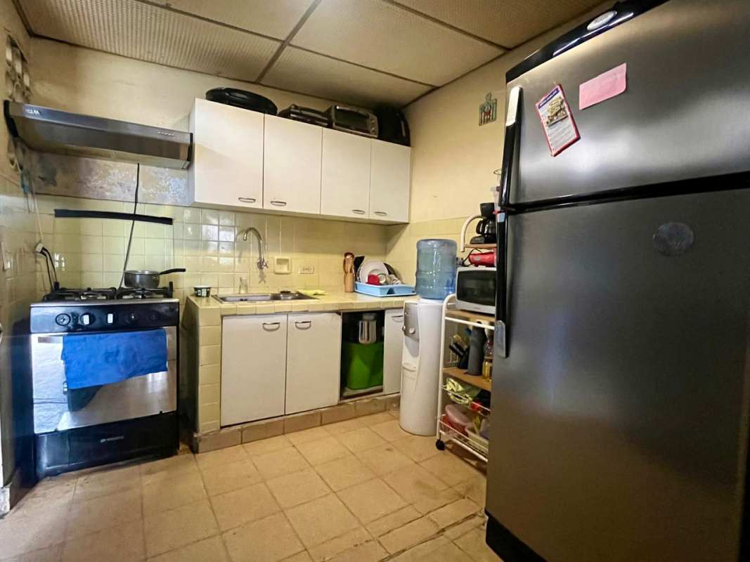 Kitchen with stove refrigerator microwave tile backsplash Villa Venus Panama City