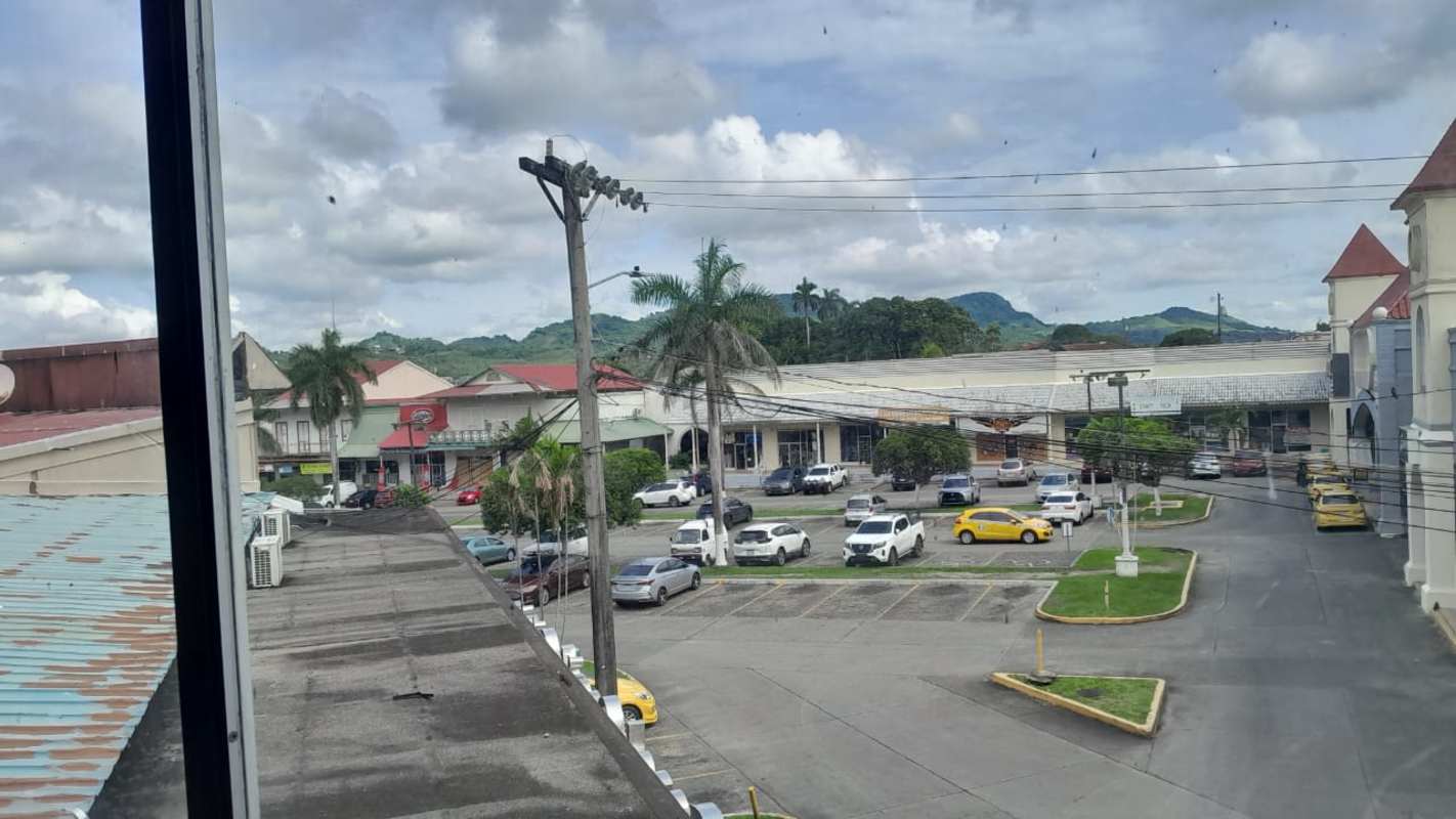 Parking area with palm trees, storefronts, mountain views at Plaza Mis Provincia commercial plaza Milla 8 Panama
