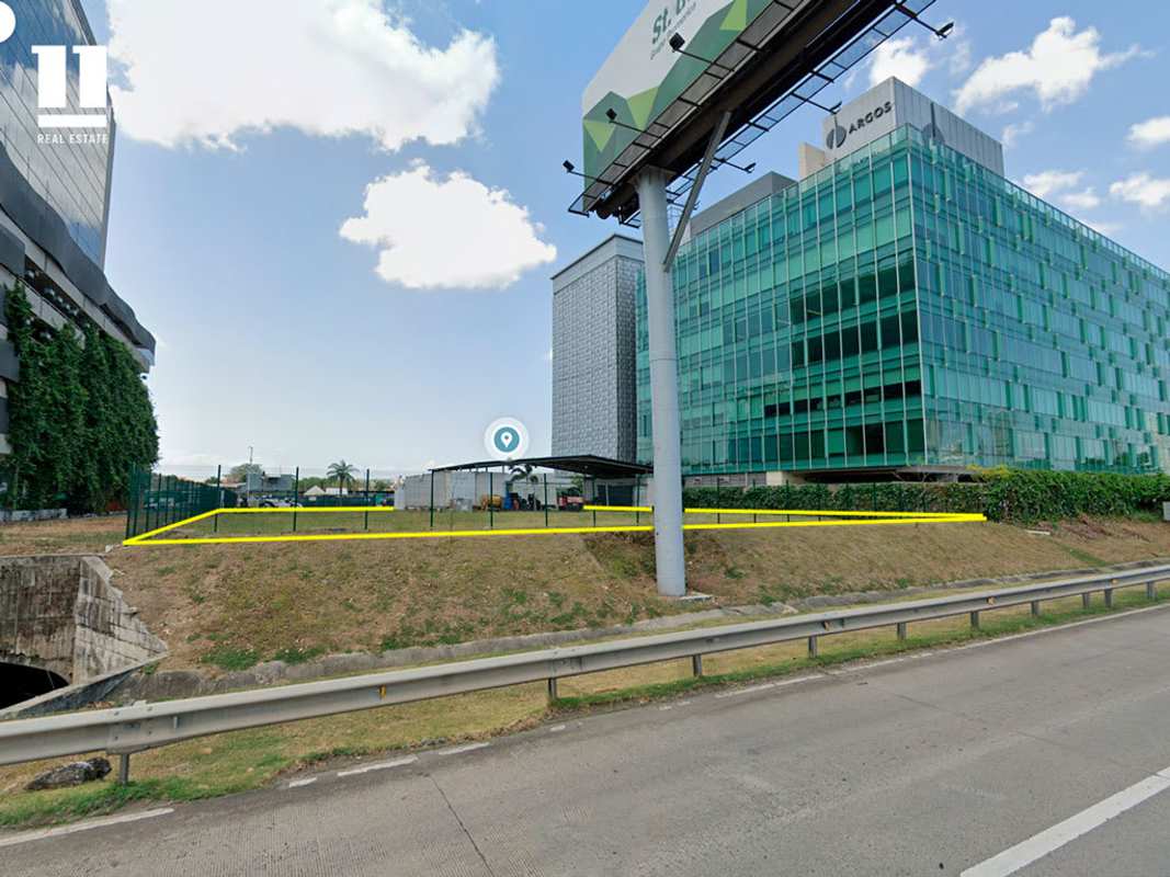 Facade of Santa María Business District with vacant lot and modern office buildings Panama City