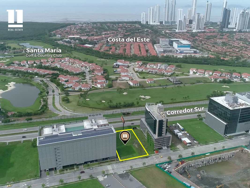 Modern office towers and commercial plot facing busy Corredor Sur highway Panama City