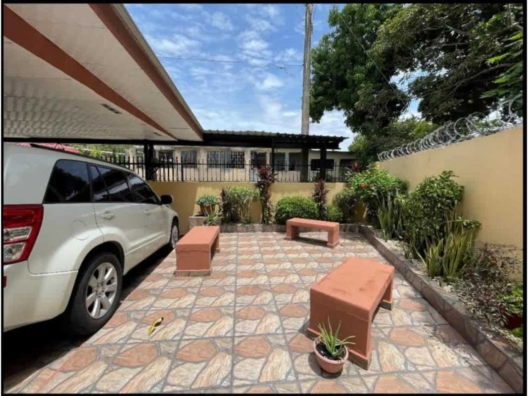 Outdoor courtyard with plants, benches, tile flooring within fenced yard in Pedregal Panama