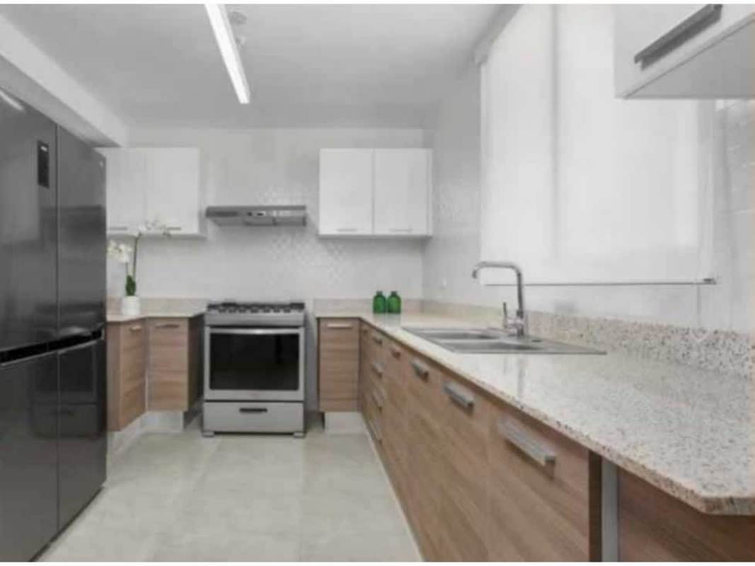 Kitchen with granite counters and stainless steel appliances in PH Kings Park Panama City