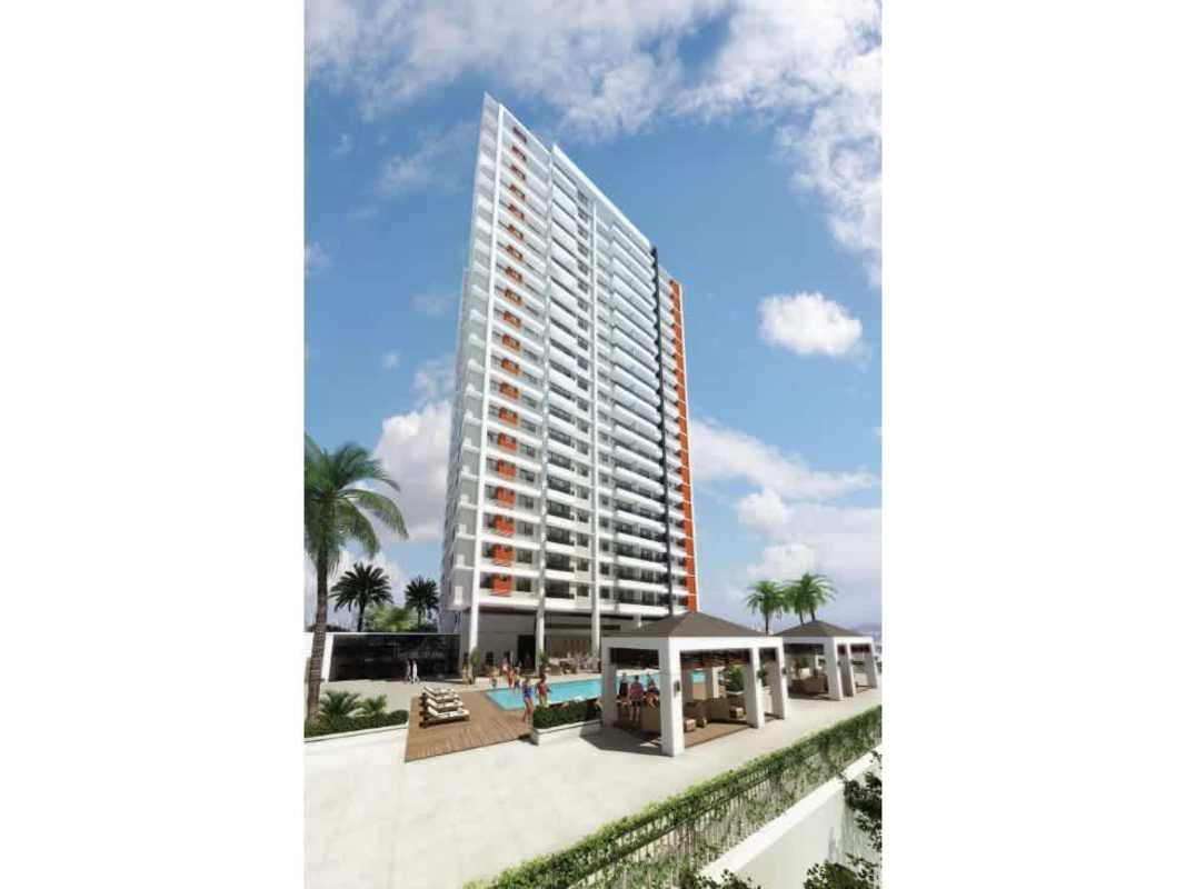 Modern high-rise residential tower with balconies and outdoor pool area at Mi Condado Condado del Rey Panama