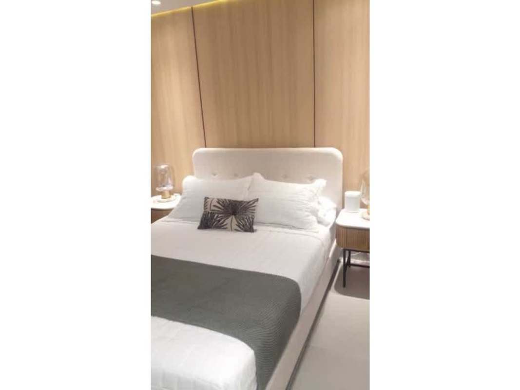 Large outdoor pool with cabanas and city background at PH Mi Condado Condado del Rey