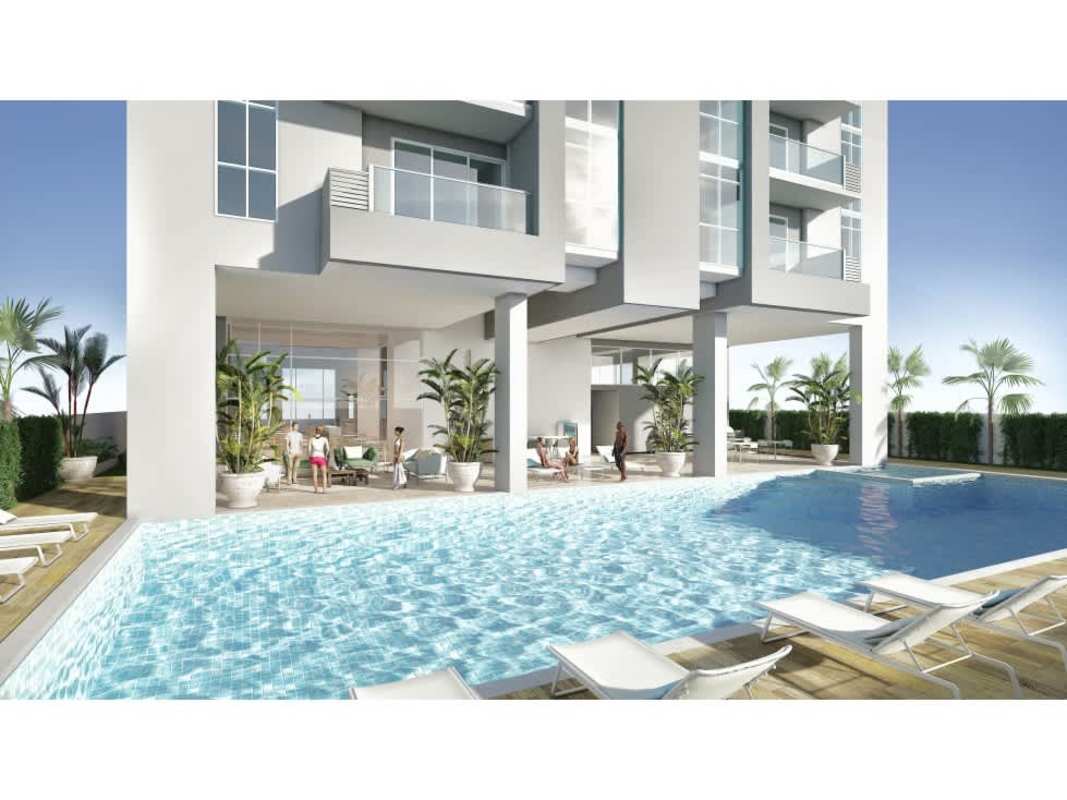 Modern apartment complex pool with lounge chairs palm trees PH Aurora San Francisco Panama