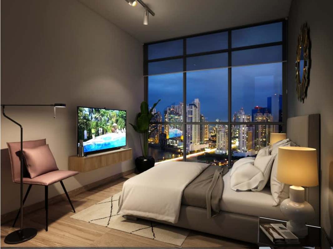 Modern bedroom with large windows overlooking Panama City skyline at night PH Aurora
