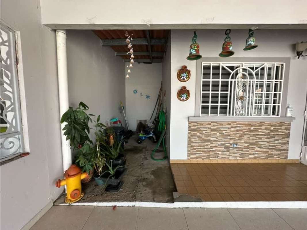 Small outdoor patio with tiled floor, stone veneer details, potted plants in Punta del Este Panama