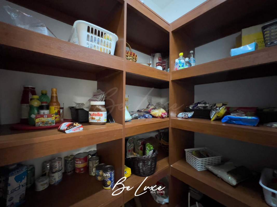 Spacious pantry with wooden shelves in luxury apartment kitchen PH Ten Tower Costa del Este