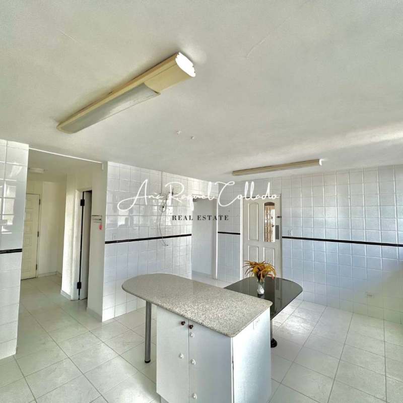 Minimalist kitchen with granite island, tiled walls, bright lighting PH Marina del Mar Panama City