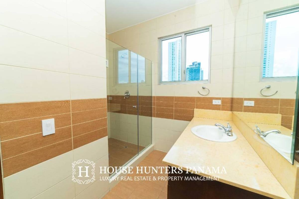 Modern balcony with glass railing featuring Pacific Ocean and skyline views in PH Ten Tower Costa del Este Panama