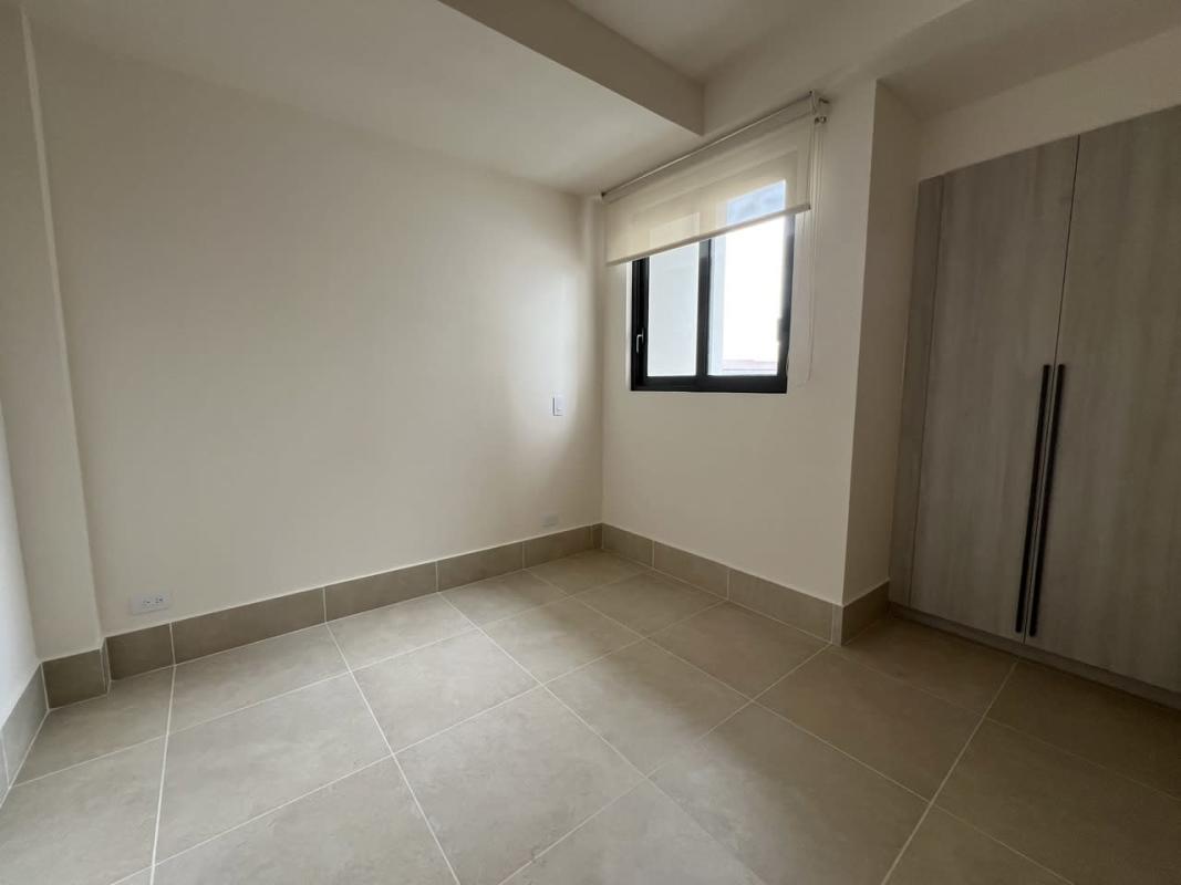 Bright living area with large windows and balcony access in Ocean House Santa Maria