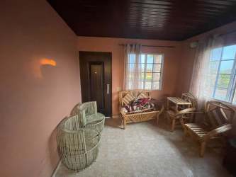 Functional kitchen with wood cabinetry and ceramic tile floor house in Santa María Divisa Panama