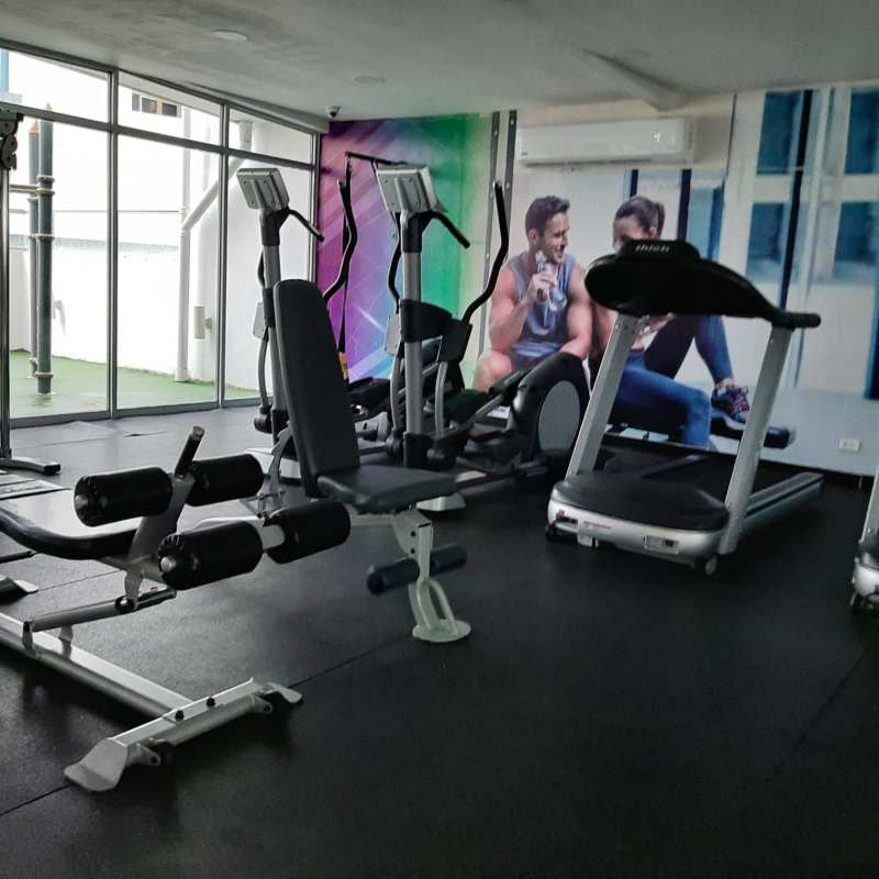 Modern fitness gym with cardio machines and mural PH Coral Towers Panama