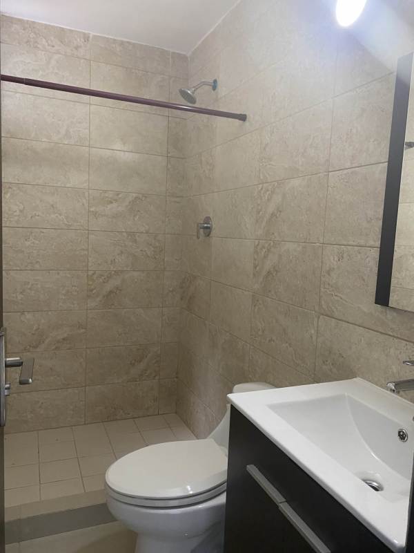 Modern bathroom with beige tiles walk-in shower and vanity PH Coral Towers Carrasquilla Panama