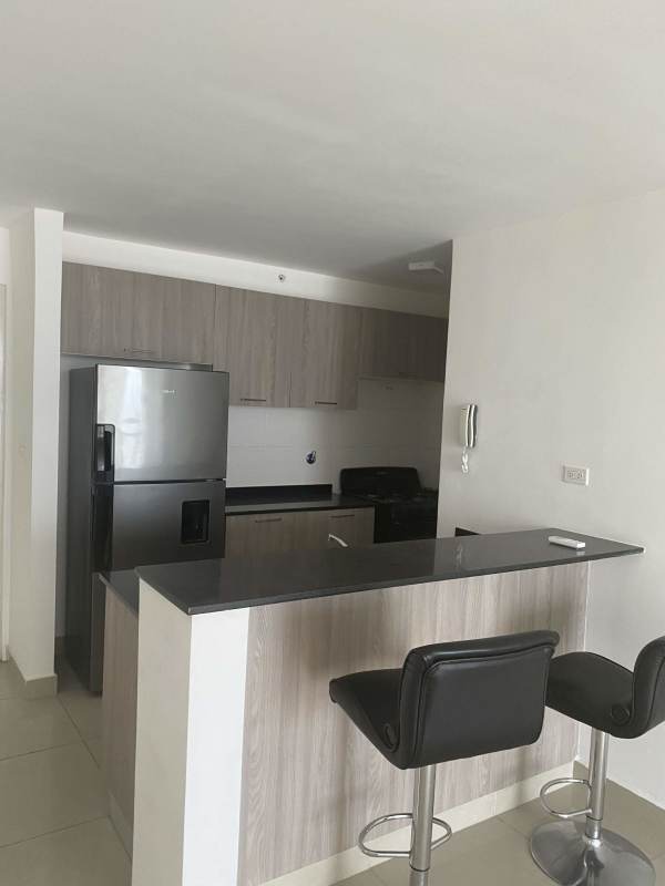 Contemporary kitchen with breakfast bar black countertops stools PH Coral Towers Panama