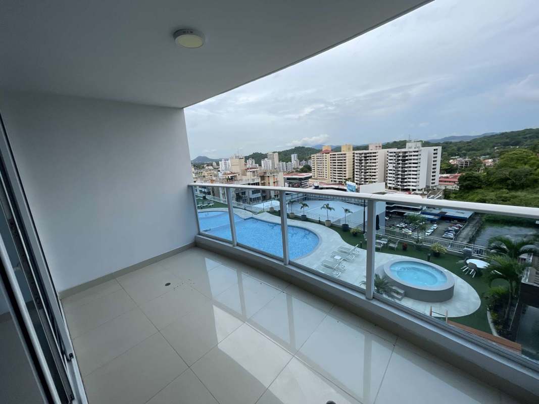 Bright modern living room with floor-to-ceiling windows leading to balcony at PH Mei Villa de Las Fuentes Panama