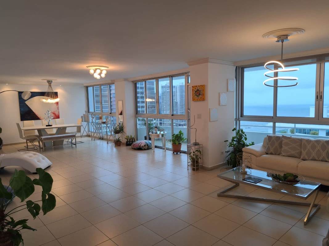 Elegant dining room with large windows and city-ocean views at PH Solmarina, Marbella Panama