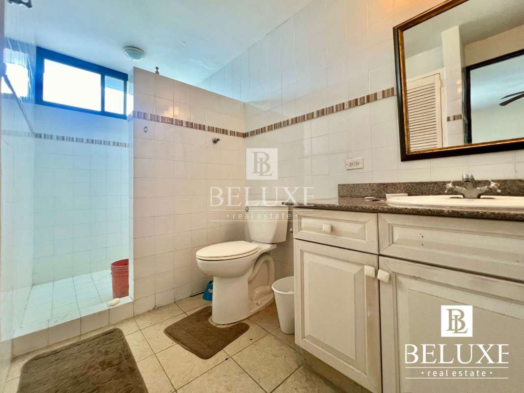 Bathroom featuring granite countertop, tile walls, glass partition PH Don Camilo Panama