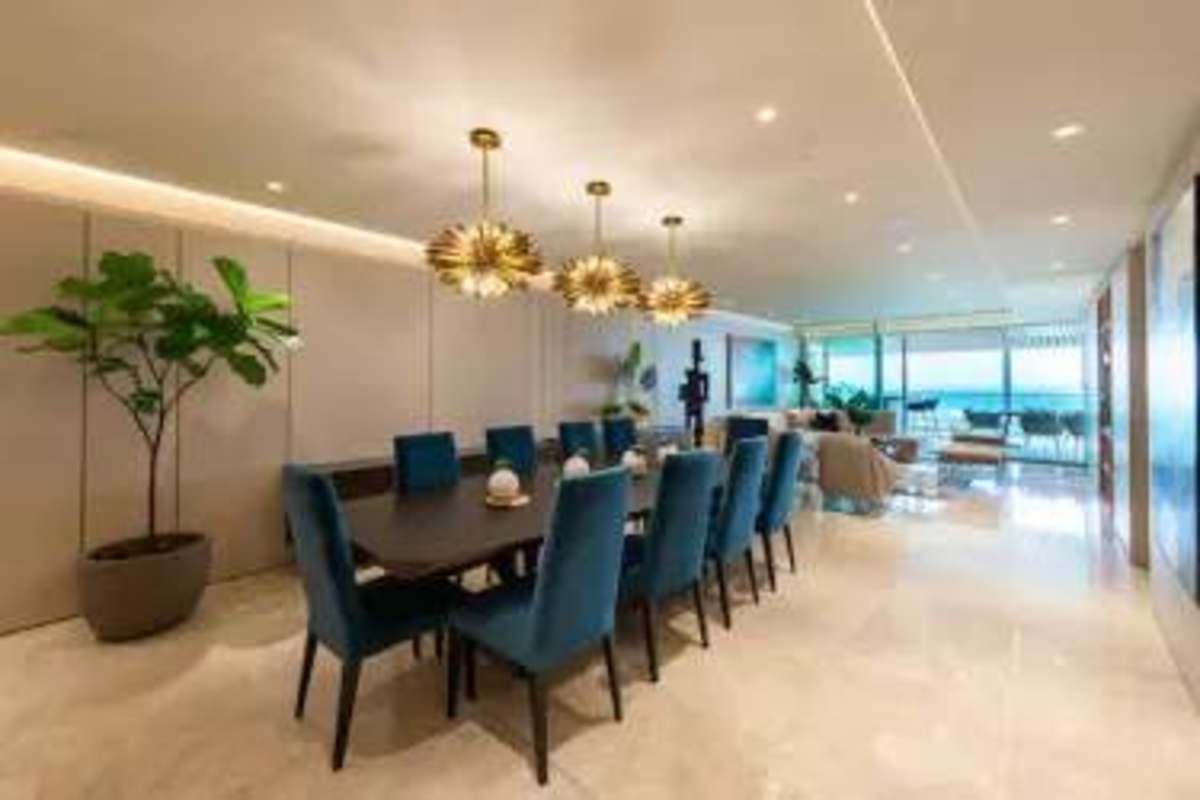 Modern dining room with marble floors and ocean backdrop in PH Costanera