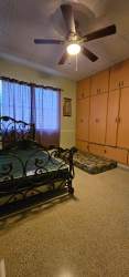 Primary bedroom with large closet, ceiling fan and window in El Vigía Chitré