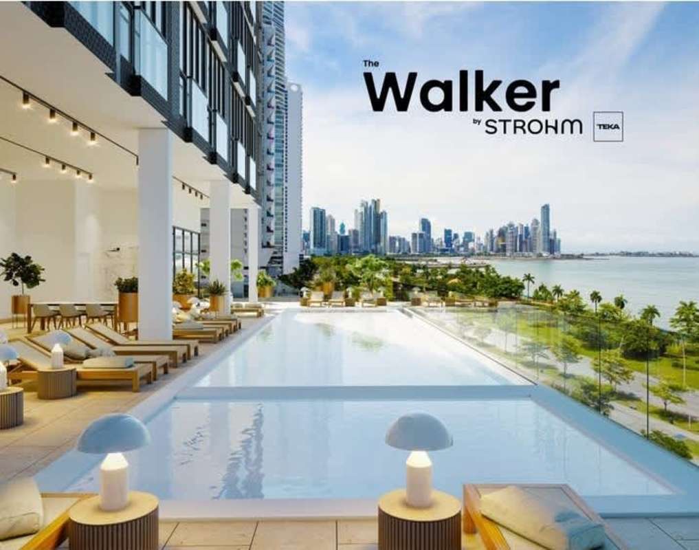 Modern rooftop terrace with infinity pool, sun loungers, dining area overlooking Panama skyline at The Walker Avenida Balboa