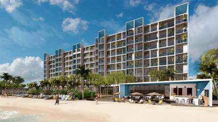 Modern beach condos with glass balconies viewing Pacific Ocean at Surfside Playa Caracol Chame Panama