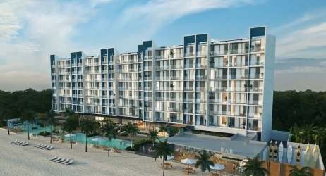 Modern beachfront condominium towers with pools and private beach access at Playa Caracol Panama