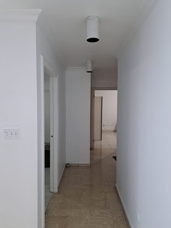 Minimalist corridor with marble tiled floors and recessed lighting PH Pacific Hills Panama
