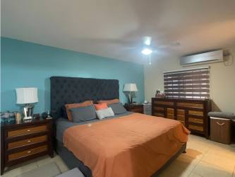 Furnished master bedroom with AC, ceiling fan in gated El Mirador house for sale Panama