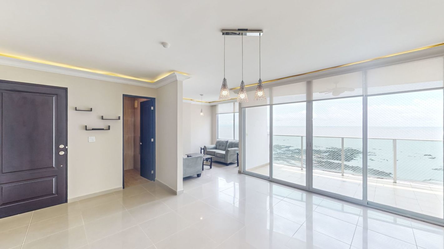 Elegant modern dining area with large windows, ocean view, tile floors, at PH Ocean Drive Punta Pacifica