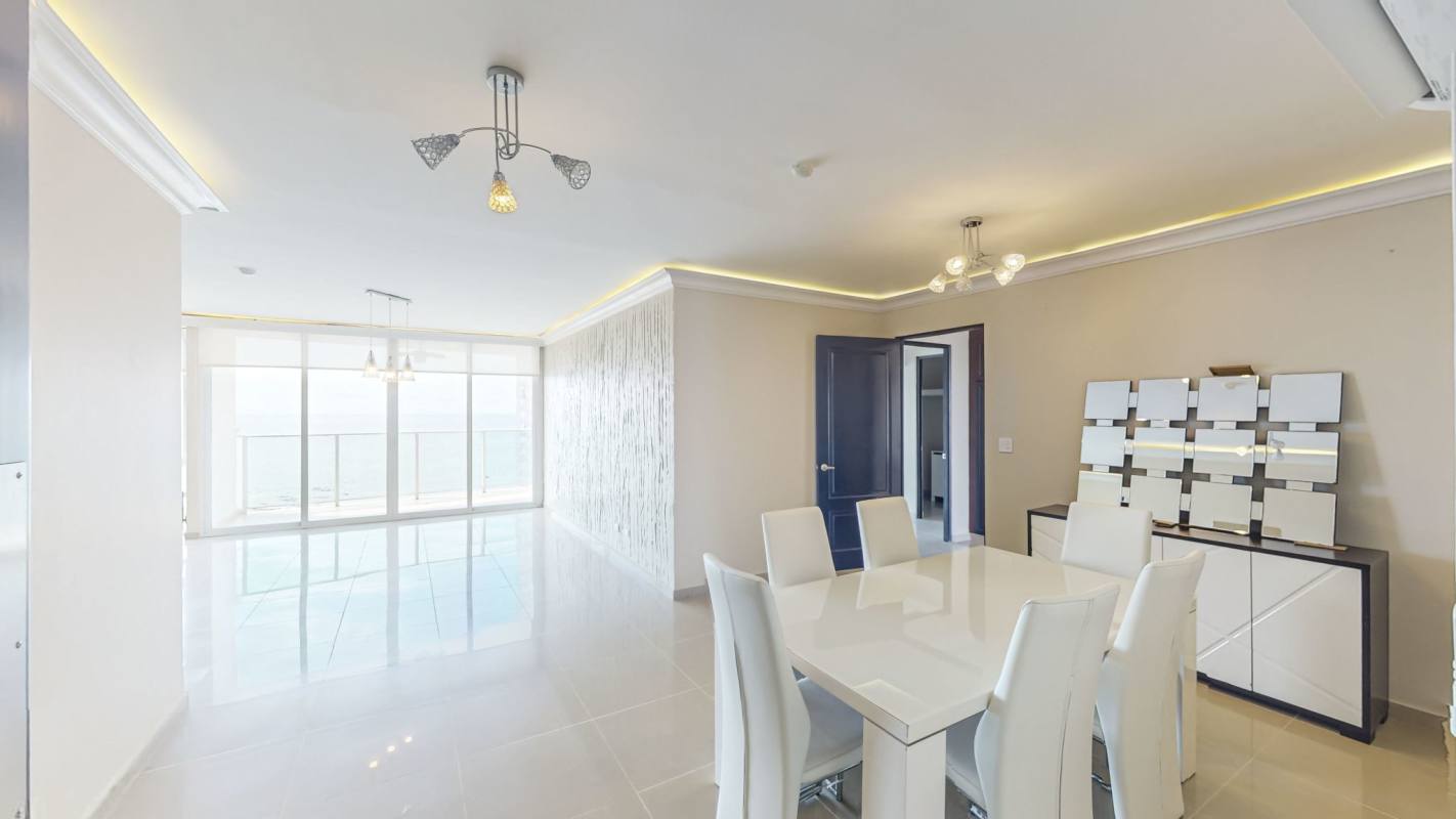 Spacious kitchen with island, wood cabinets, built-in appliances in PH Ocean Drive luxury apartment Panama City